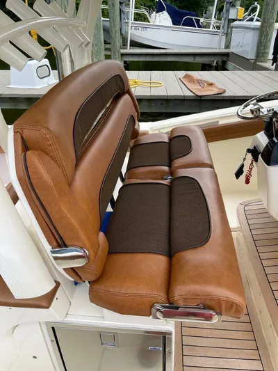  Yacht Photos Pics Luxurious brown leather seating on a 2016 Scout 350 LXF boat at a dock.