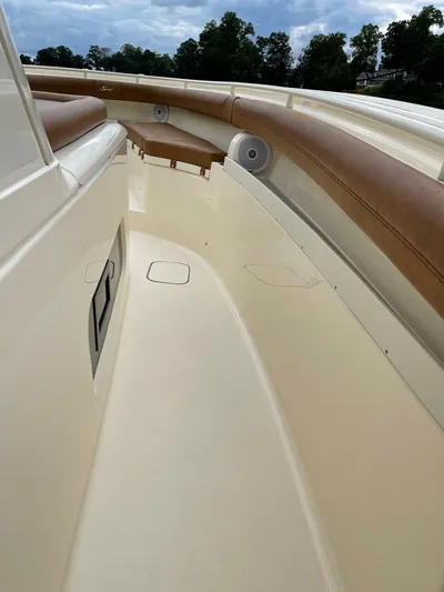  Yacht Photos Pics 2016 Scout 350 LXF boat interior with cushioned seating and speakers.