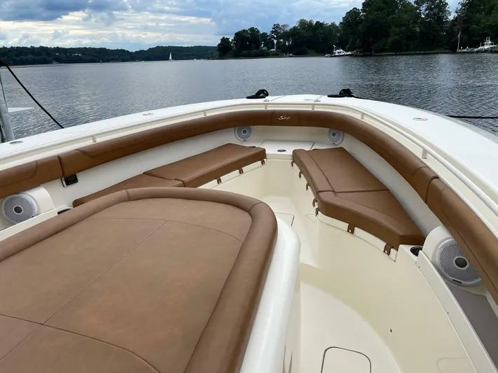  Yacht Photos Pics Luxurious 2016 Scout 350 LXF boat interior with brown seating on a serene lake.