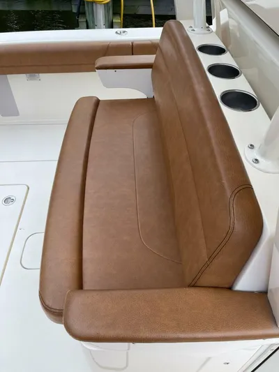  Yacht Photos Pics Brown leather seating on 2016 Scout 350 LXF boat, featuring cup holders.