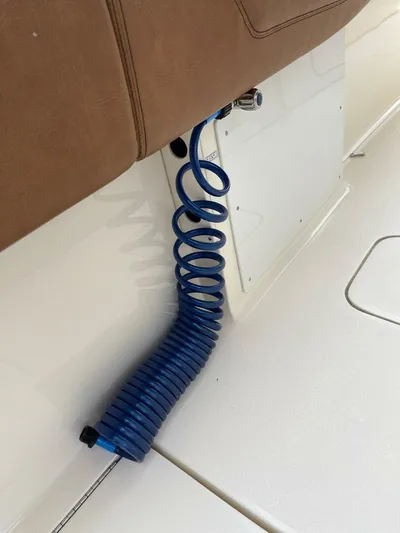  Yacht Photos Pics Blue coiled hose on 2016 Scout 350 LXF boat, attached to brown seat.