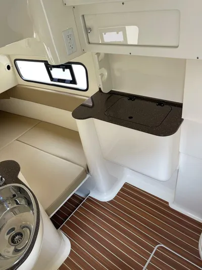  Yacht Photos Pics 2016 Scout 350 LXF cabin interior with seating, sink, and wood-patterned flooring.