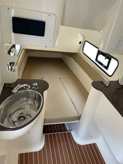  Yacht Photos Pics 2016 Scout 350 LXF cabin interior with sink, bed, and wood flooring.