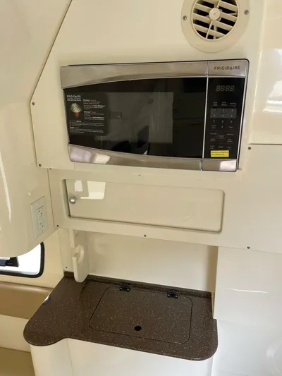  Yacht Photos Pics Frigidaire microwave in 2016 Scout 350 LXF boat interior, featuring a compact kitchen setup.