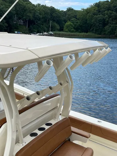  Yacht Photos Pics 2016 Scout 350 LXF boat with rod holders on a calm lake.