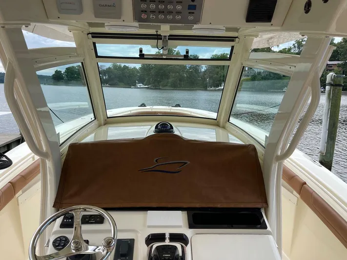  Yacht Photos Pics Interior view of 2016 Scout 350 LXF boat cockpit with steering wheel and controls.