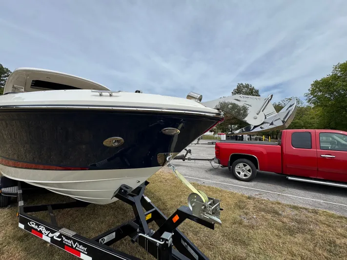  Yacht Photos Pics 2022 Sea Ray SLX 310 boat on trailer, hitched to a red truck.