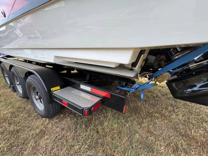  Yacht Photos Pics 2022 Sea Ray SLX 310 boat on a trailer, secured with blue straps.