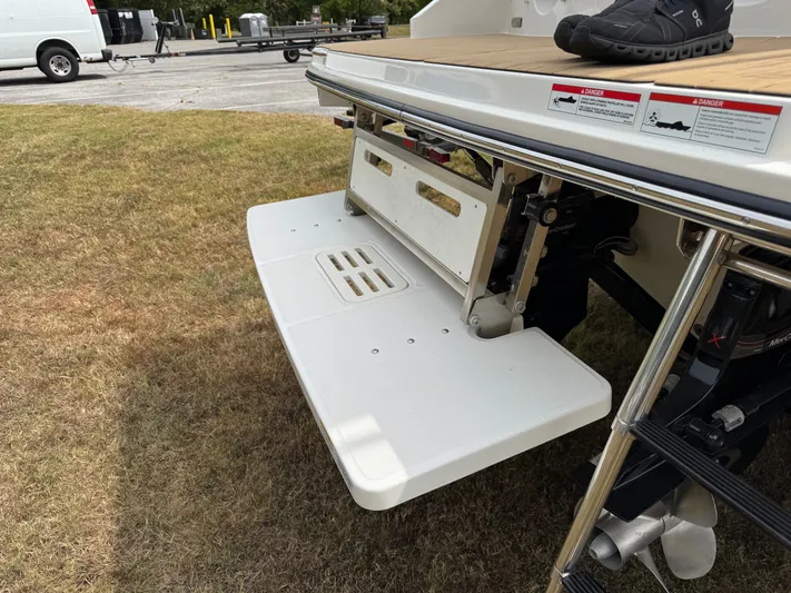  Yacht Photos Pics 2022 Sea Ray SLX 310 swim platform with ladder, parked on grass.