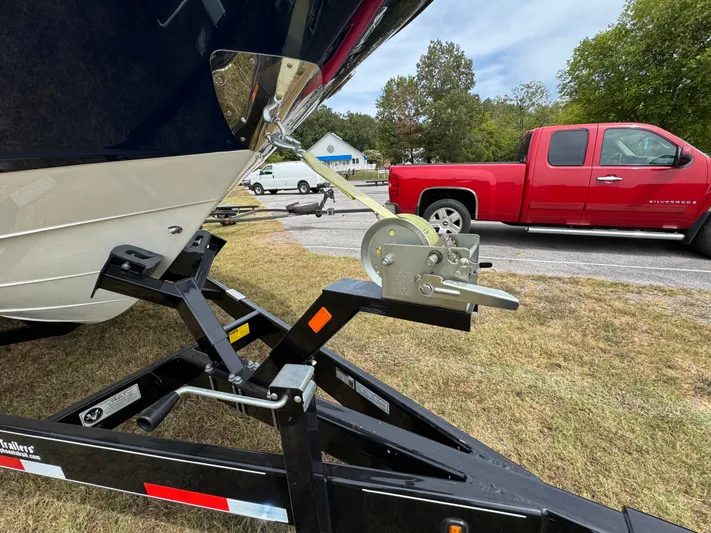  Yacht Photos Pics 2022 Sea Ray SLX 310 boat on trailer, parked near red truck.