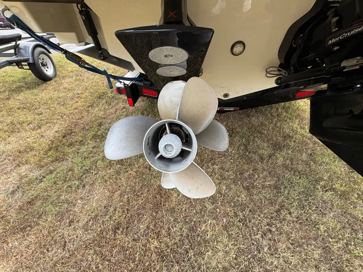  Yacht Photos Pics Propeller of 2022 Sea Ray SLX 310 boat on grass.