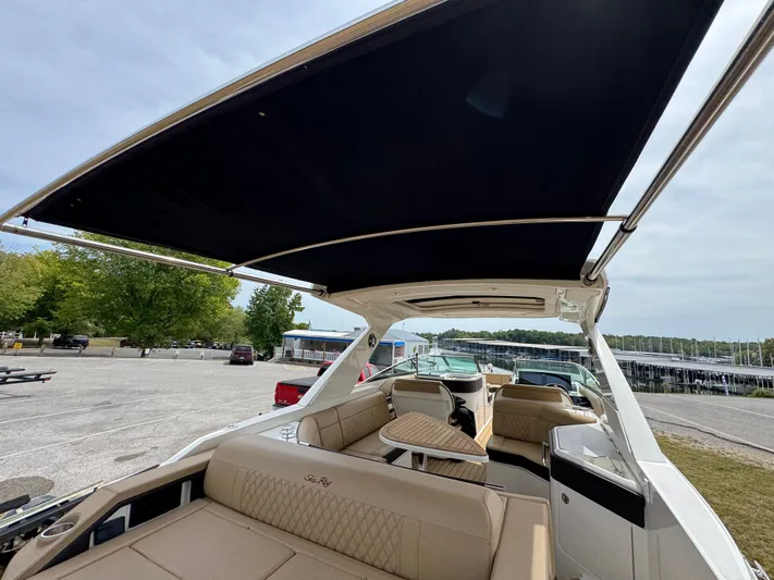  Yacht Photos Pics 2022 Sea Ray SLX 310 boat with spacious seating and canopy, docked outdoors.