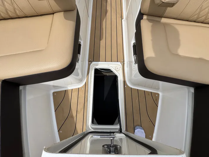  Yacht Photos Pics 2022 Sea Ray SLX 310 interior with tan seating and wood-style flooring.
