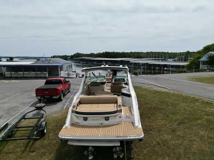  Yacht Photos Pics 2022 Sea Ray SLX 310 boat on trailer near marina, with red truck nearby.