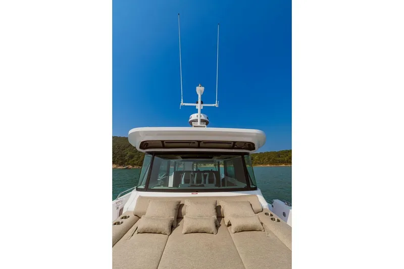  Yacht Photos Pics Axopar 45 XC Cross Cabin 2024 with sun deck and blue sky.