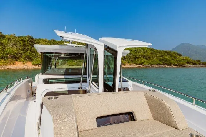  Yacht Photos Pics Axopar 45 XC Cross Cabin 2024 on calm waters with open cabin.