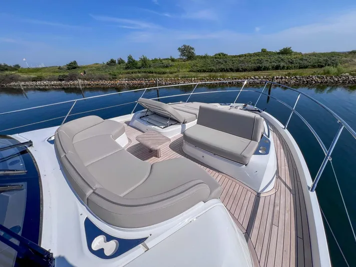 F65020 Yacht Photos Pics 2024 Princess F65 yacht with luxurious deck seating on calm water.