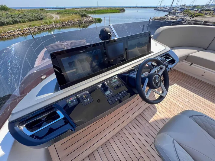 F65020 Yacht Photos Pics 2024 Princess F65 yacht helm with modern controls and scenic marina view.