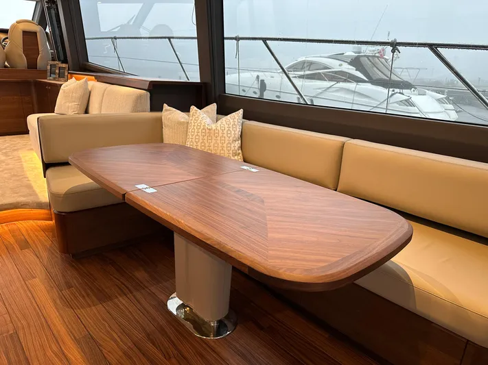 F65020 Yacht Photos Pics Luxurious interior of 2024 Princess F65 yacht with elegant wood table and plush seating.