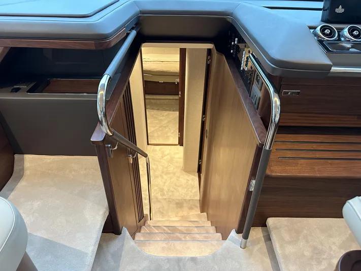F65020 Yacht Photos Pics Interior staircase of 2024 Princess F65 yacht, featuring elegant wood finish and modern design.