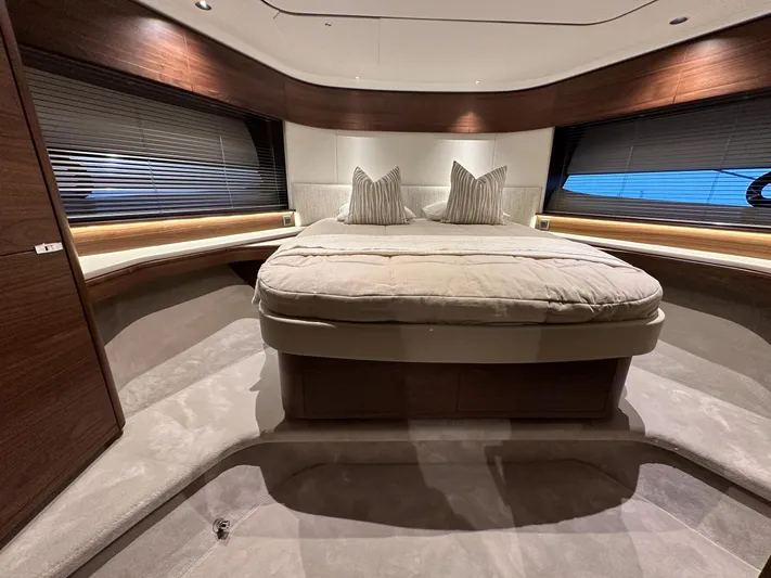 F65020 Yacht Photos Pics Luxurious bedroom interior of 2024 Princess F65 yacht with elegant design and plush bedding.