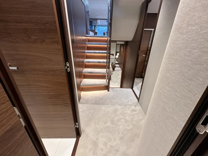 F65020 Yacht Photos Pics Luxurious interior of 2024 Princess F65 yacht with elegant wooden staircase.