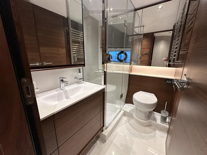 F65020 Yacht Photos Pics Luxurious bathroom in 2024 Princess F65 yacht with modern fixtures and wooden cabinetry.