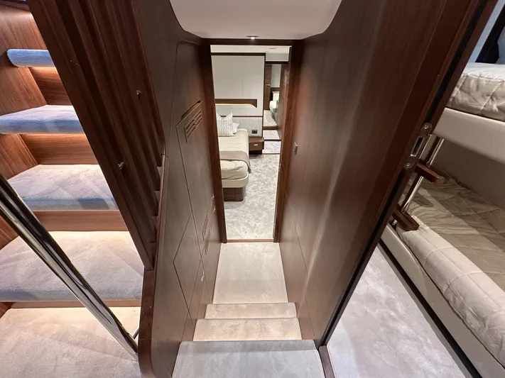 F65020 Yacht Photos Pics Luxurious interior of 2024 Princess F65 yacht, featuring elegant wood finishes and plush carpeting.