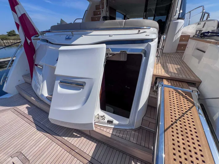 F65020 Yacht Photos Pics 2024 Princess F65 yacht with open storage compartment on teak deck.