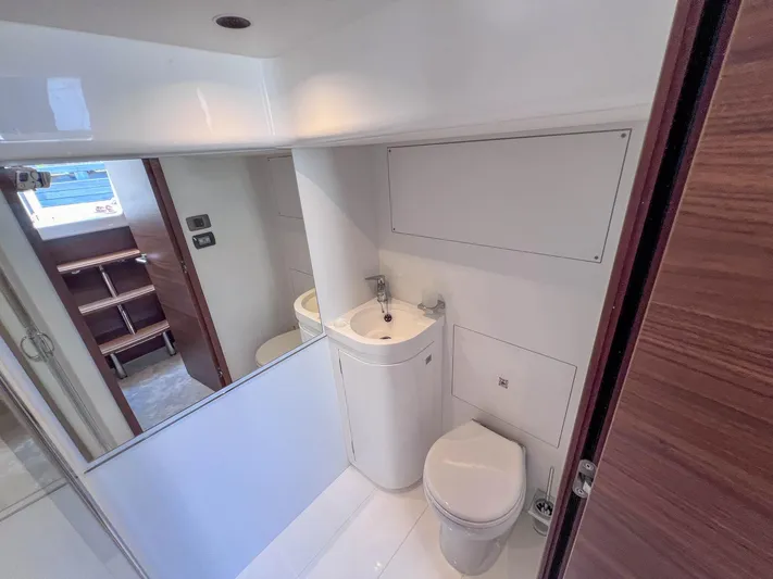F65020 Yacht Photos Pics Modern bathroom in 2024 Princess F65 yacht, featuring sleek design and compact fixtures.
