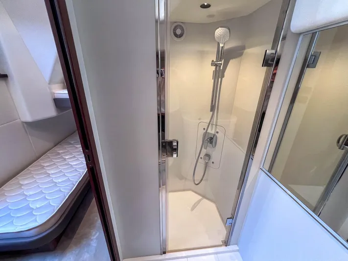 F65020 Yacht Photos Pics 2024 Princess F65 yacht interior with modern shower and adjacent sleeping area.