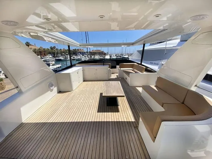 Yaiza Yacht Photos Pics Spacious deck of 2000 Astondoa 82 GLX yacht with seating and table, docked at marina.
