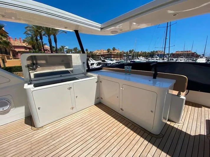 Yaiza Yacht Photos Pics Astondoa 82 GLX 2000 yacht deck with outdoor kitchen and marina view.