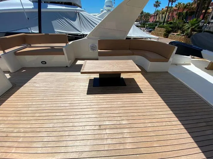 Yaiza Yacht Photos Pics Astondoa 82 GLX 2000 yacht deck with wooden flooring and cushioned seating area.