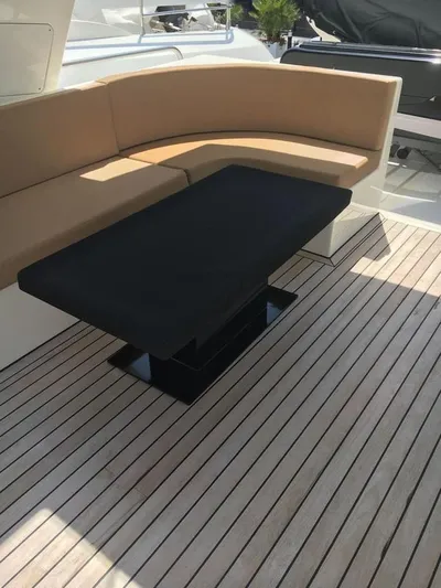 Yaiza Yacht Photos Pics Luxury yacht deck with beige seating and black table, Astondoa 82 GLX, 2000 model.