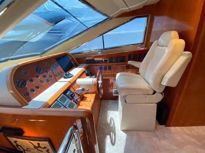 Yaiza Yacht Photos Pics Luxurious helm of 2000 Astondoa 82 GLX yacht with leather seat and wooden dashboard.