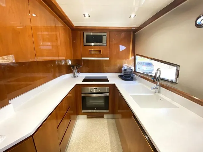 Yaiza Yacht Photos Pics Luxurious kitchen in 2000 Astondoa 82 GLX yacht with modern appliances and sleek design.