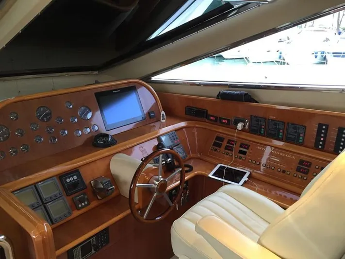 Yaiza Yacht Photos Pics Cockpit of 2000 Astondoa 82 GLX yacht with wooden dashboard and modern navigation equipment.