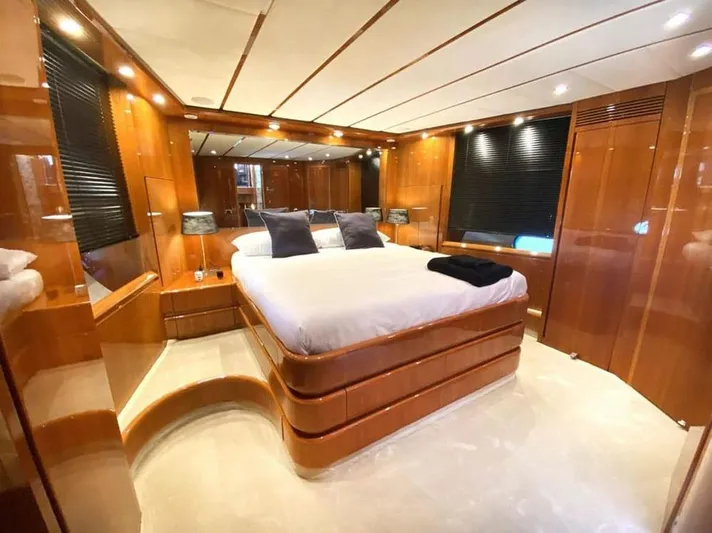 Yaiza Yacht Photos Pics Luxurious bedroom interior of 2000 Astondoa 82 GLX yacht with elegant wood paneling.