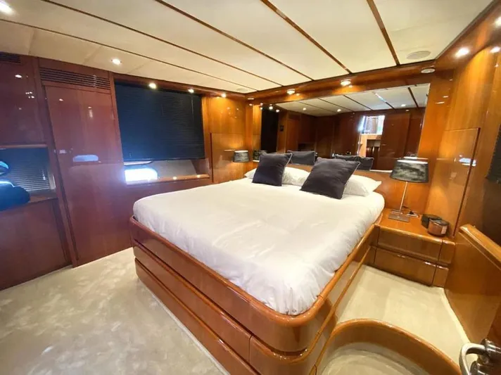 Yaiza Yacht Photos Pics Luxurious bedroom interior of 2000 Astondoa 82 GLX yacht with elegant wood paneling.