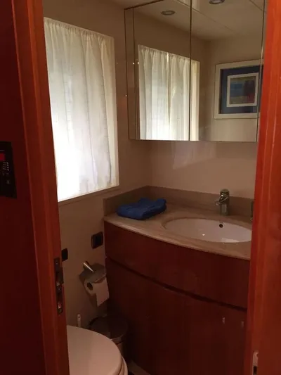Yaiza Yacht Photos Pics Bathroom interior of 2000 Astondoa 82 GLX yacht with mirror and sink.