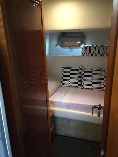 Yaiza Yacht Photos Pics Cozy cabin interior of 2000 Astondoa 82 GLX yacht with stylish bedding and porthole.