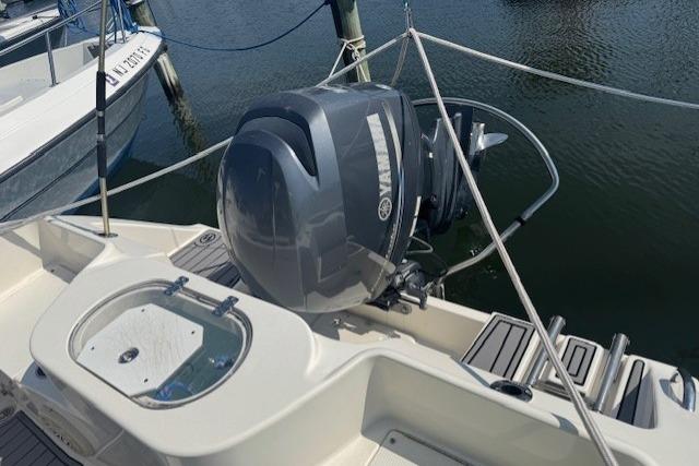 2014 Cobia 217 Center Console boat with Yamaha outboard motor docked at marina.