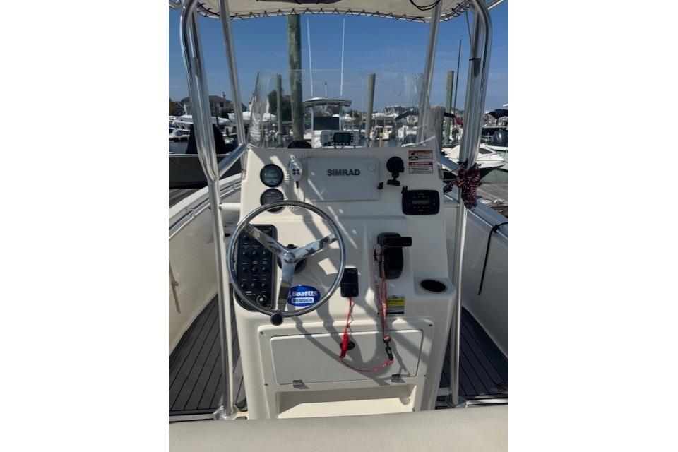 2014 Cobia 217 Center Console boat dashboard with steering wheel and navigation equipment.
