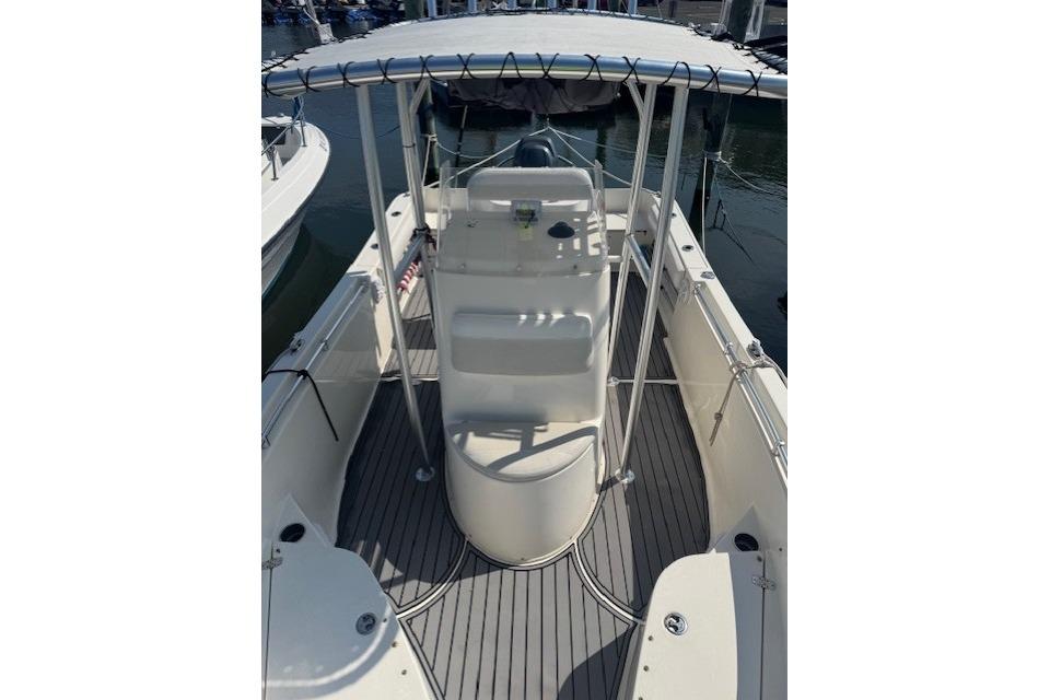 2014 Cobia 217 Center Console boat with T-top and spacious deck.