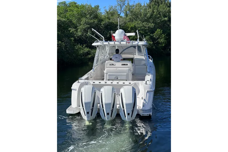 No Name Yacht Photos Pics 2020 Intrepid 409 Valor boat with triple engines cruising on a calm waterway.