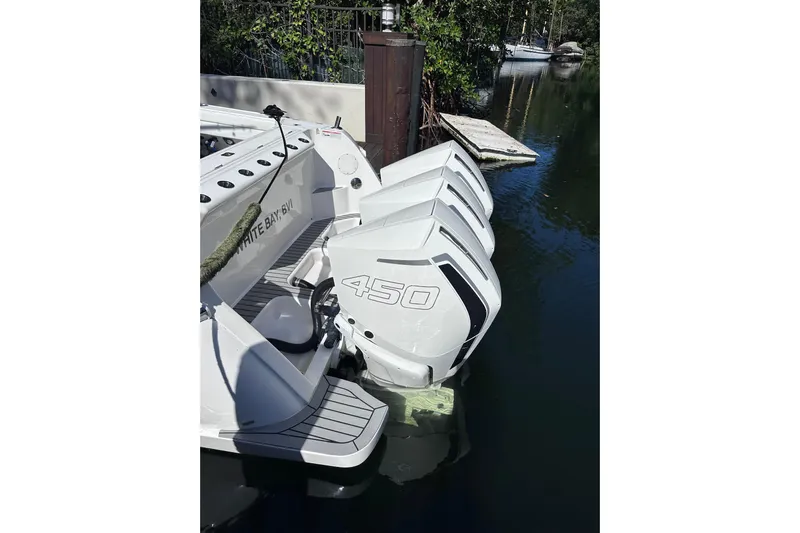 No Name Yacht Photos Pics 2020 Intrepid 409 Valor with triple 450 engines docked in a serene waterway.