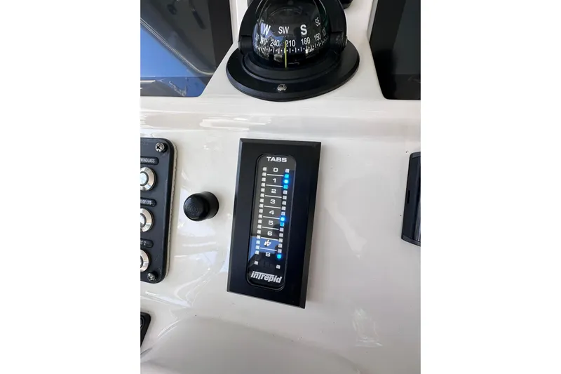 No Name Yacht Photos Pics Control panel of 2020 Intrepid 409 Valor boat with compass and tab settings.