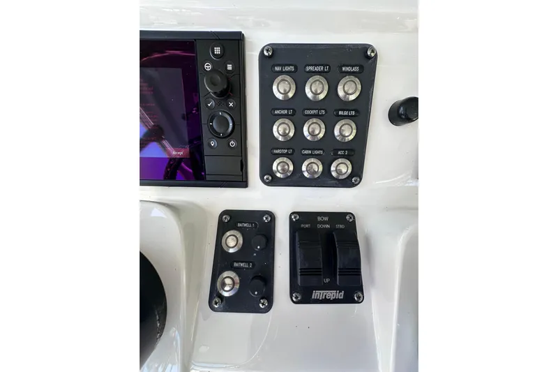 No Name Yacht Photos Pics Control panel of a 2020 Intrepid 409 Valor boat with various switches and buttons.