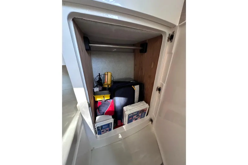 No Name Yacht Photos Pics Storage compartment in 2020 Intrepid 409 Valor boat, containing safety and utility equipment.